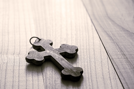 wooden cross on a wooden surface,  close up