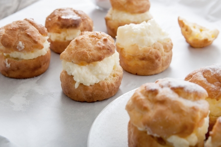 Profiteroles on a plate on wooden background