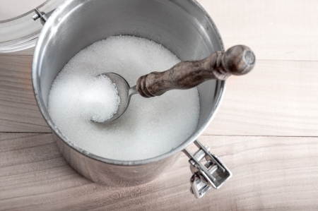 Metal sugar bowl on a wooden backgroundの写真素材