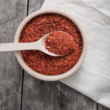 Overhead close up view of a bowl of ground red cayenne pepper の写真素材