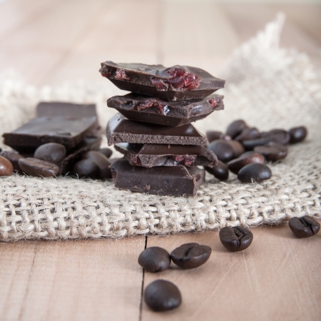 Chocolate pieces tower on a wooden surface, close upの写真素材