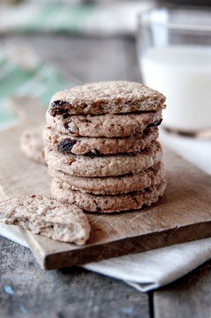 Stacked chocolate chip cookies on old wooden tableの写真素材
