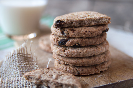 chocolate chip cookies and milk on wooden tableの写真素材