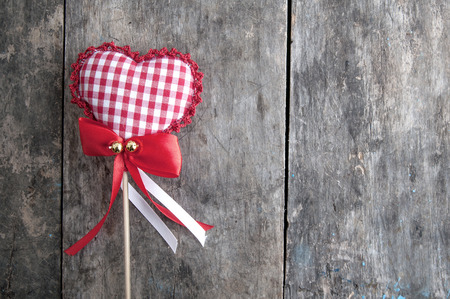 handmade  knitted heart shape on wooden backgroundの写真素材