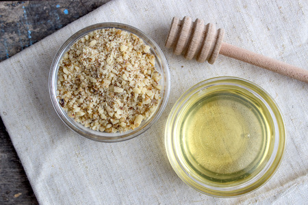 walnut and honey in glass bowl on tableの写真素材