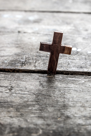 Wooden cross on a wooden background, backlitの写真素材