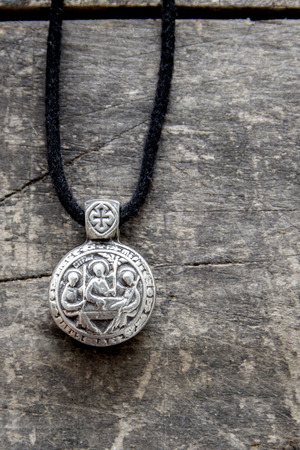 old pendant over wooden background, close upの写真素材