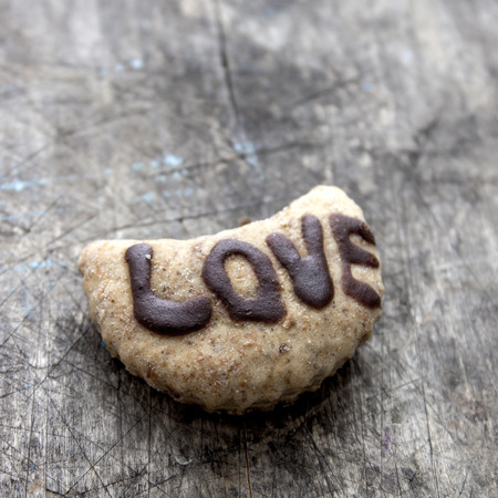 Close up of homemade love cookies on wooden backgroundの写真素材