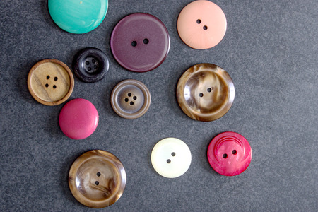 collection of old  buttons on table, from above