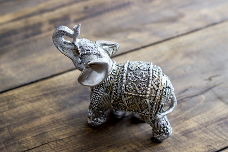 Indian Elephant Figurine on wooden table, close upの写真素材