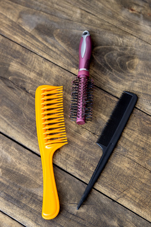 Old used hair brushes on wooden table, from aboveの写真素材