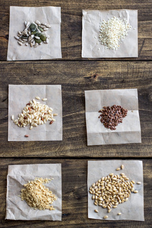 Seeds and cereals. Different kind of seeds and cereals on the wooden tableの写真素材