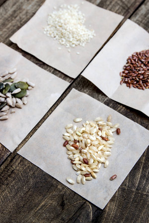 Seeds and cereals. Different kind of seeds and cereals on the wooden tableの写真素材