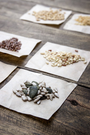 Seeds and cereals. Different kind of seeds and cereals on the wooden tableの写真素材