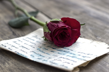 Love letter and rose on wooden background,close upの写真素材