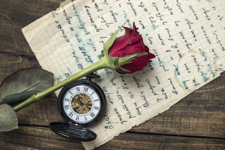 Love letter and rose on wooden background, from aboveの写真素材