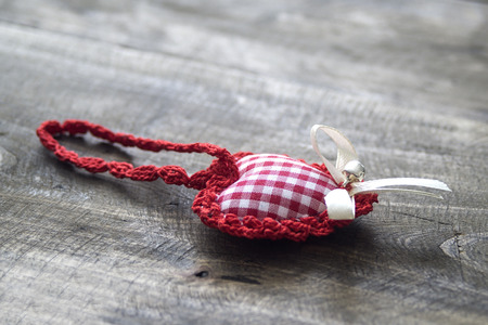 handmade knitted heart shape on wooden backgroundの写真素材