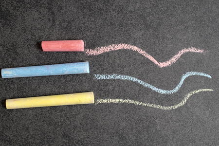 Colored chalk on a blackboard background, from aboveの写真素材