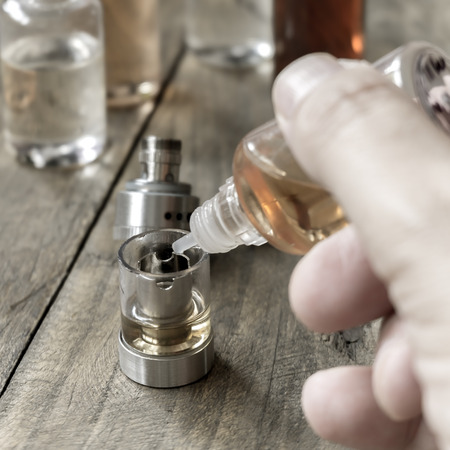e-cigarettes with lots of different re-fill bottles, close up