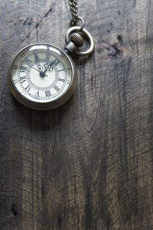 Time - Vintage Pocket Watch on Weathered Wood Background, from aboveの写真素材