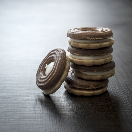 Cookies with chocolate cream on a wooden table