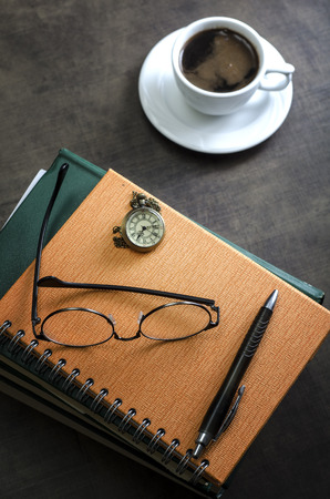 Stack of books and a pair of glasses on top of it. Close upの写真素材