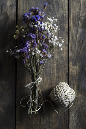 Bouquet of dried flowers on wooden table, from aboveの写真素材