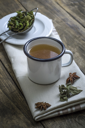 Cup of herbal tea on a wooden background, close upの写真素材