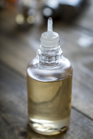 Electronic cigarette liquid flavour on wooden background, close upの写真素材