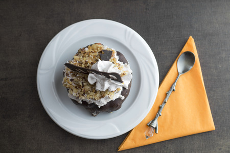 Piece of cake on the wooden table, top view