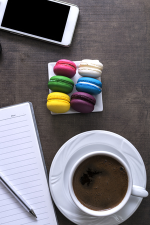 Cup of coffee  and colorful macaroons  on the deskの写真素材