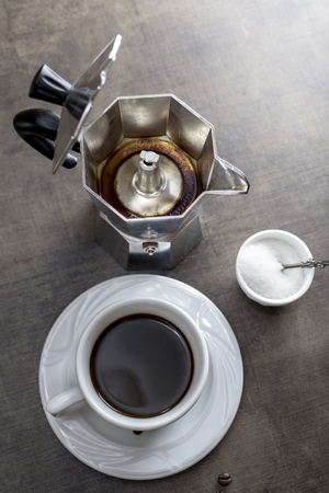 Cup of coffee with coffee  maker on wooden backroundの写真素材