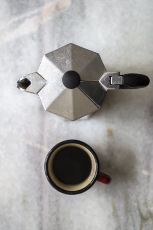Top view of espresso pot and coffee cup on the tableの写真素材