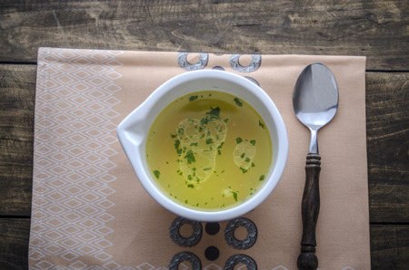 chicken noodle soup on wooden table, from aboveの写真素材