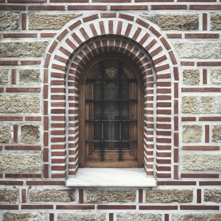 The ancient rounded window in close upの写真素材