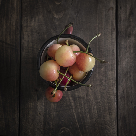 Freshly picked cherries on dark wooden table, from aboveの写真素材