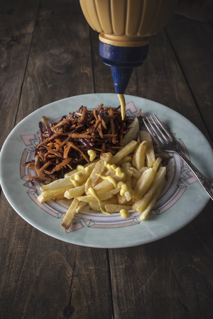 French fries with mustard in close upの写真素材
