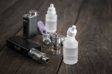 Kit for healthy smoking on wooden background, e-cigaretteの写真素材