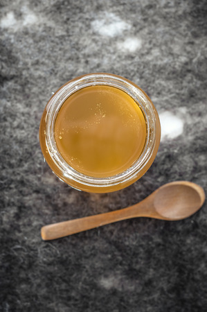 Organic Honey in a  jar on table, top viewの写真素材