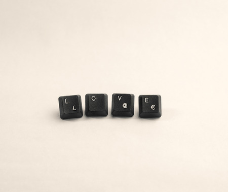 Love spelled out using keyboard keys, black and whiteの写真素材