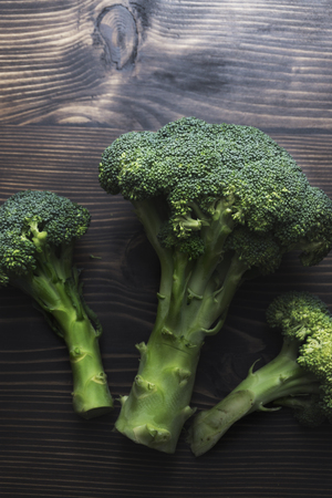 Broccoli on a wooden table, rustic styleの写真素材