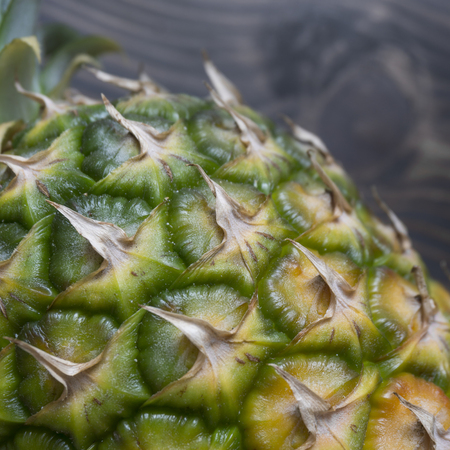 Close up photo of ripe pineapple on a  wooden tableの写真素材