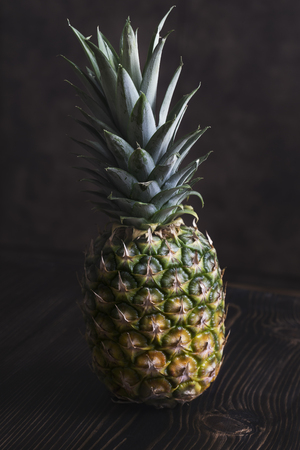 Ripe pineapple on a  wooden table,close upの写真素材