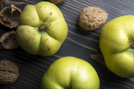 Fresh quince fruits on wooden table, feom aboveの写真素材