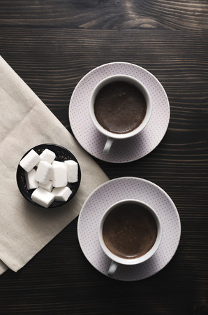Two cups of coffee with cubes of sugar on table, from aboveの写真素材