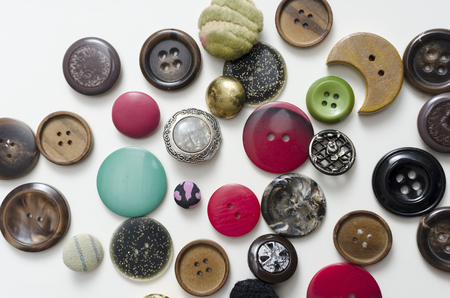 Lot Of Colorful Buttons on White Wooden Table, close upの写真素材