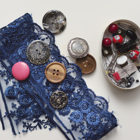 Tools and accessories for sewing on light wooden background.の写真素材