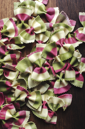 Italian raw multicolored farfalle pasta. View from aboveの写真素材