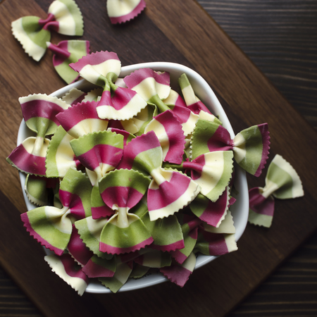 Italian raw multicolored farfalle pasta. View from aboveの写真素材