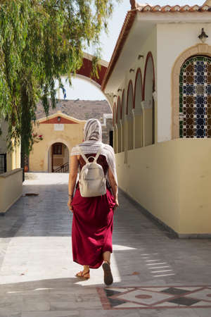 Woman entering the church on the Greek orthodox monasteryの写真素材